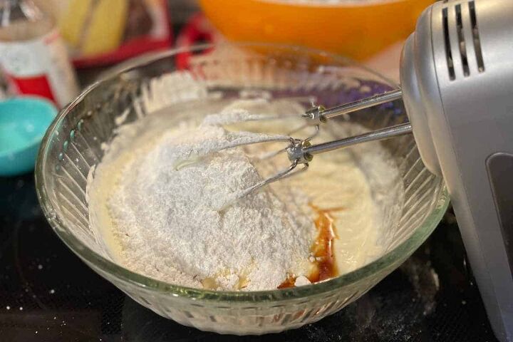 pumpkin crunch cake with yellow cake mix, powedered sugar and vanilla added to cream cheese and heavy cream with an electric mixer for the icing for pumpkin crunch