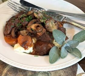 how to make creamy and delicious mashed sweet potatoes, white bowl with raised dot edge fresh sage beef potatoes mushrooms silver fork silver knife
