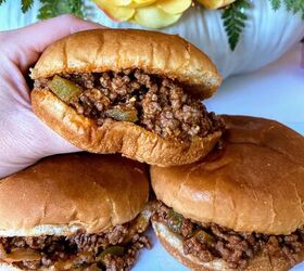 old fashioned sloppy joes recipe, hand holding sloppy joes and two sandwiches resting on a plate