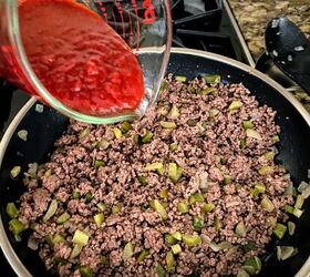 old fashioned sloppy joes recipe, adding chili sauce to meat and veggie mixture for old fashioned sloppy joes recipe
