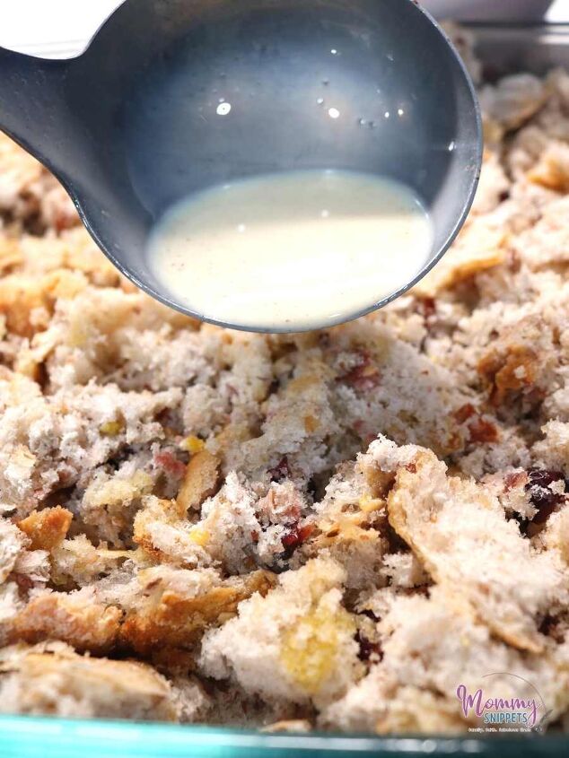 sourdough bread pudding with condensed milk an easy holiday recipe, pouring milk mixture over sourdough fragments for sourdough bread pudding