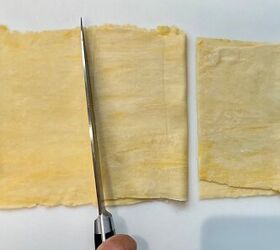 brazilian pastel recipe with beef filling, knife cutting squares of dough that have been folded over for Brazilian Pastel recipe