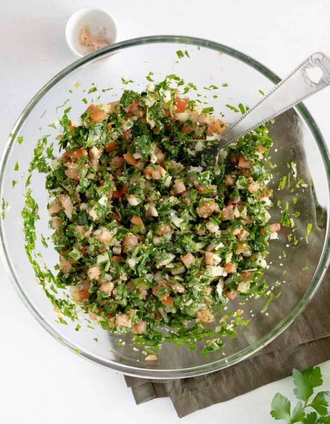 authentic lebanese taboule salad, chopped parsley onion tomato with burghul in a glass bowl