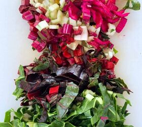 lebanese lemon lentil soup adas bi hamod, chopped up chard on a white chopping board