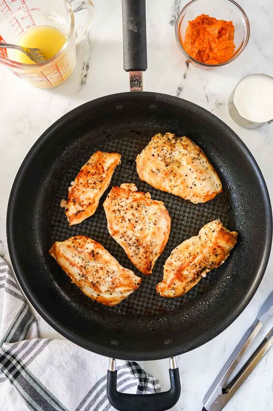 sun dried tomato pesto chicken, Seasoned chicken breasts cooking in a large skillet