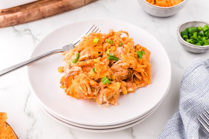 mexican chicken casserole with doritos, A plate of this cheesy chicken casserole with Doritos on a white plate with a fork