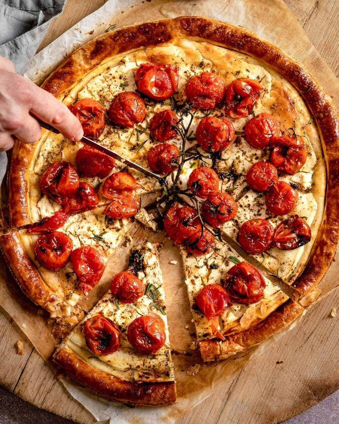 roasted cherry tomatoes tart with cheese, Someone slicing the Tomatoes Tart viewing from above