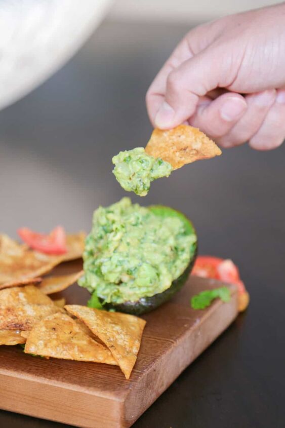 tasty guacamole recipe without tomatoes, tortilla chip dipped into guacamole