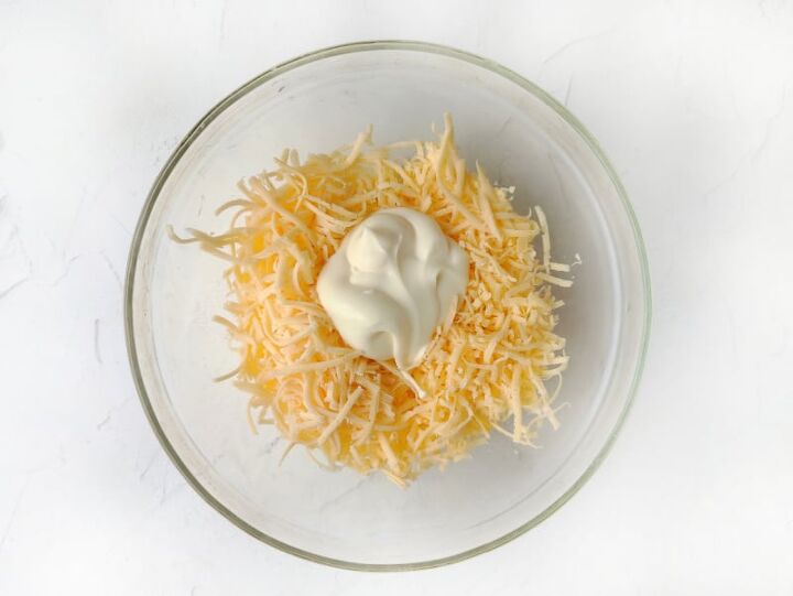 russian cheese salad recipe, cheese and mayonnaise in a bowl