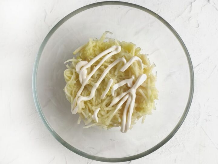 russian cheese salad recipe, apple and mayonnaise in a bowl