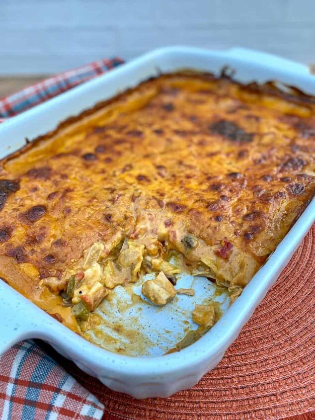 king ranch chicken casserole happy honey kitchen, King Ranch Chicken Casserole in a large baking dish with a scoop taken out exposing chicken veggies and sauce on the inside