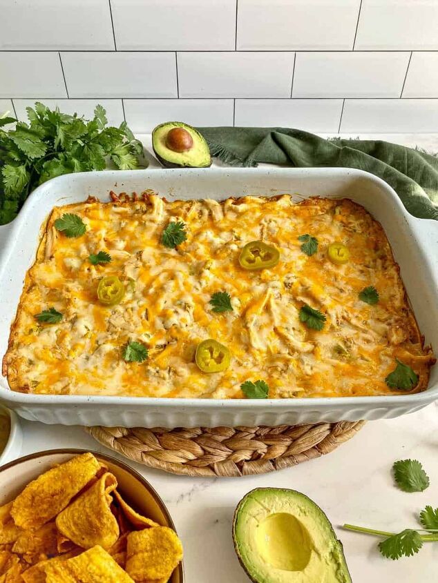sour cream chicken enchilada casserole happy honey kitchen, Tex Mex casserole in a large baking dish with melted cheese and jalapeno peppers on top