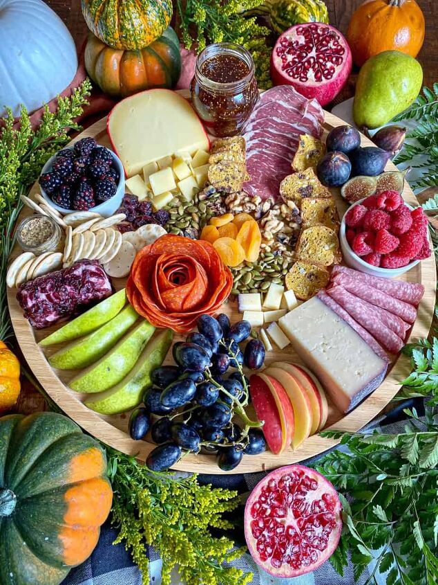 fall charcuterie board happy honey kitchen, A fall themed charcuterie board full of cheeses meats and fruits Greenery and fresh pumpkins surround the wooden board