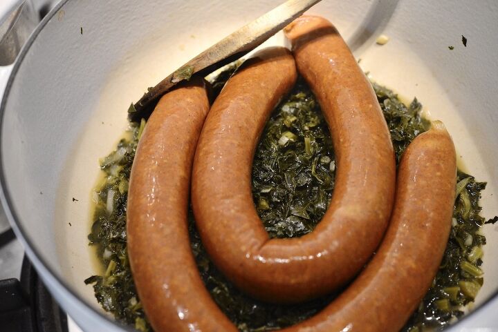the best braised kale german style, sausages and braised kale in pot with spoon
