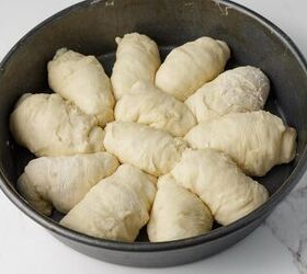 homemade yeast dinner rolls, A cake pan filled with homemade dinner rolls before being baked