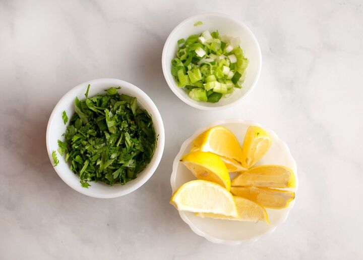 lemongrass chicken soup, Chopped cilantro and green onions and lemon wedges in bowls for garnishes