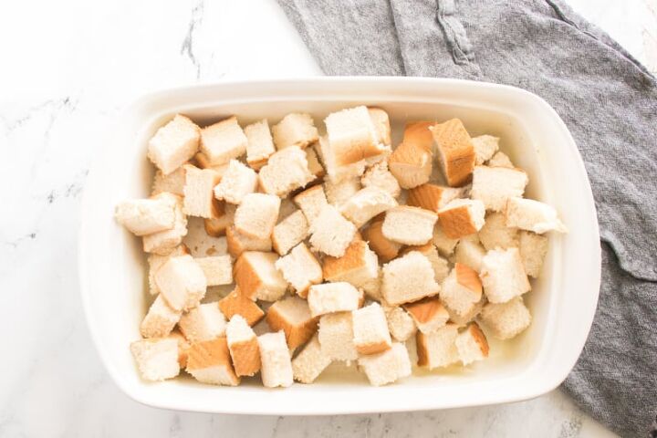 pumpkin pie french toast recipe, bread cubes in a white baking dish