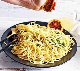 easy lemon garlic pasta pasta al limone, Hand squeezing grilled lemon on pasta
