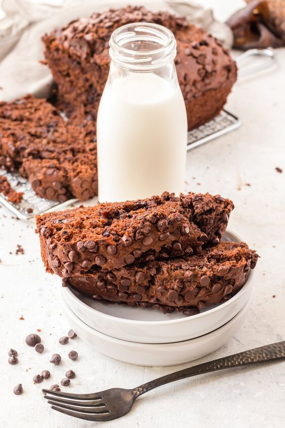 double chocolate banana bread, Sliced chocolate banana bread on a white plate with a milk bottle on the table