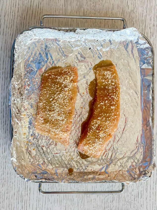 air fryer salmon with dijon mustard sauce, process shot showing uncooked air fryer salmon in an air fryer basket