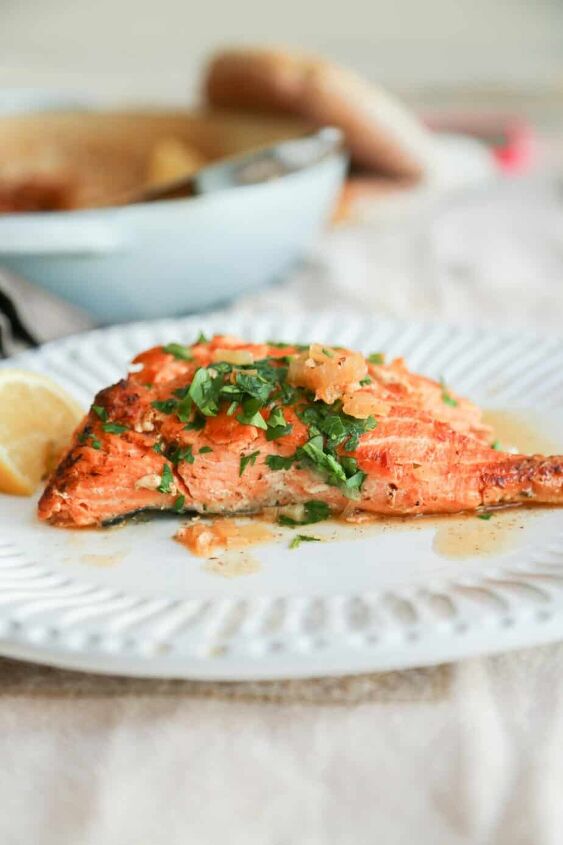 air fryer salmon with dijon mustard sauce, keto salmon recipe with lemon butter sauce on a plate with lemon and parsley