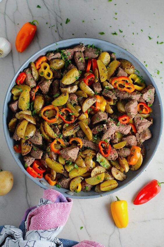 mouthwatering potato and steak bites recipe, Garlic Potato and Steak Bites Recipe with sweet pepper slices in a pan on counter It s an easy and delicious one pan family dinner You get fantastic salty buttery tender steak and potatoes in each and every mouthwatering bite