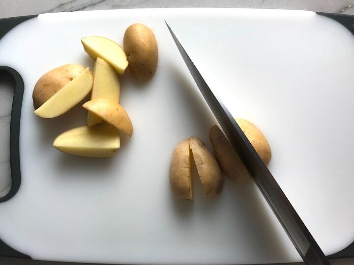mouthwatering potato and steak bites recipe, Knife slicing creamer potatoes for Garlic Potato and Steak Bites Recipe It s an easy and delicious one pan family dinner You get fantastic salty buttery tender steak and potatoes in each and every mouthwatering bite