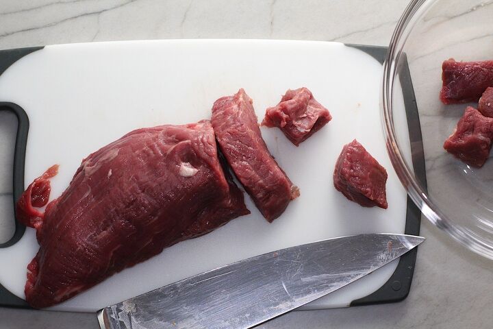mouthwatering potato and steak bites recipe, Knife slicing petite beef filet into steak bites for Garlic Potato and Steak Bites Recipe It s an easy and delicious one pan family dinner You get fantastic salty buttery tender steak and potatoes in each and every mouthwatering bite