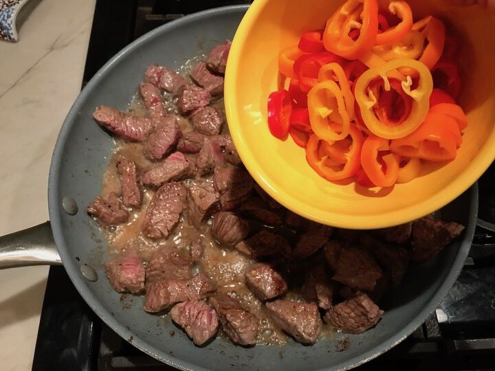 mouthwatering potato and steak bites recipe, Adding sliced sweet peppers to steak bites for Garlic Potato and Steak Bites Recipe It s an easy and delicious one pan family dinner You get fantastic salty buttery tender steak and potatoes in each and every mouthwatering bite