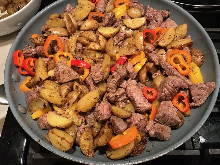 mouthwatering potato and steak bites recipe, Garlic Potato and Steak Bites Recipe with sweet pepper slices in a pan on counter It s an easy and delicious one pan family dinner You get fantastic salty buttery tender steak and potatoes in each and every mouthwatering bite