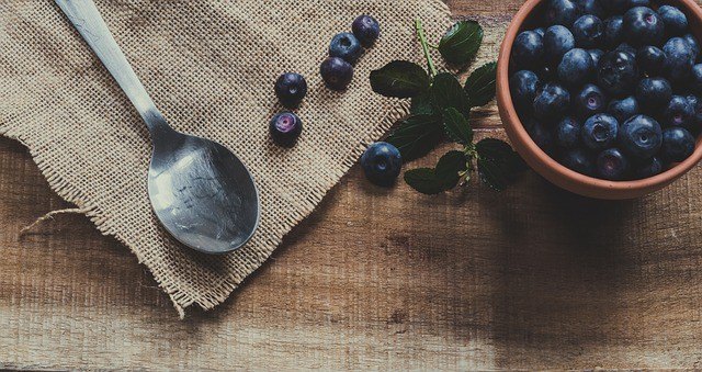 lemon blueberry pancake recipe, blueberries in a bowl on a wooden surface