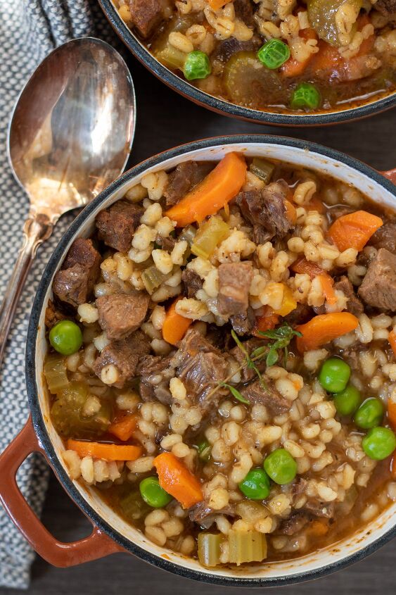instant pot beef barley soup crockpot stove top, Hearty beef barley soup made in the instant pot There s a fresh thyme sprig on top of the soup and you can see the bright carrots and peas There s a slightly tarnished spoon next to the bowl