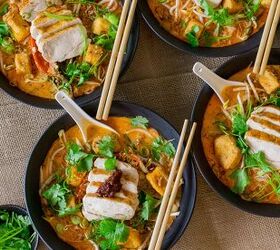 thai chicken laksa, Thai laksa served in a bowl with chicken noodles herbs and toppings