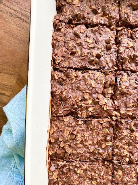 brownie baked oatmeal, White baking dish or brownie oatmeal bars cut into squares