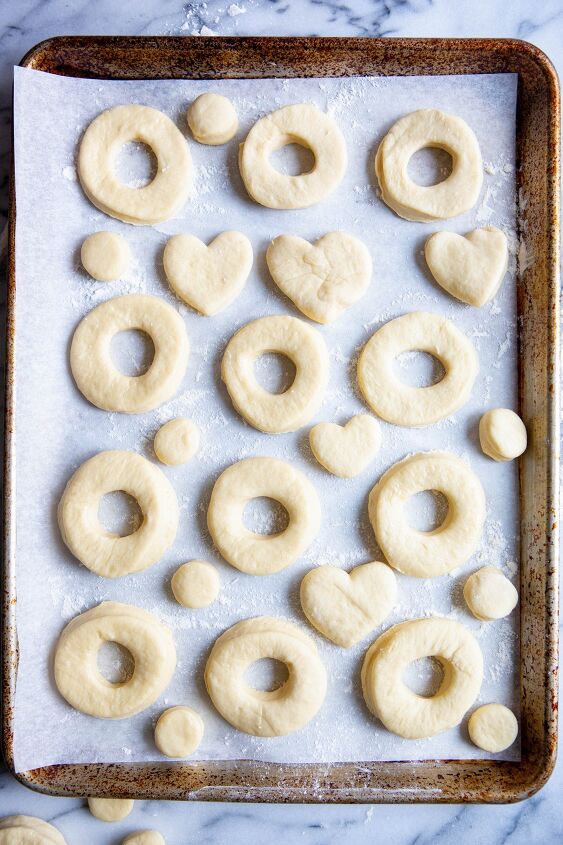 valentine donuts in air fryer basic recipe, cut out donuts on a cookie sheet lined with parchment paper