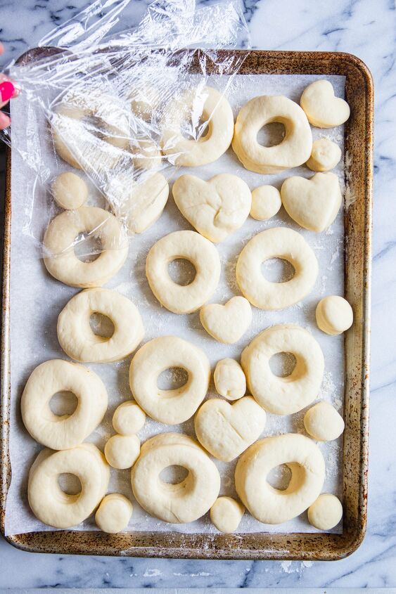 valentine donuts in air fryer basic recipe, risen donuts on a baking sheet ready to be fried