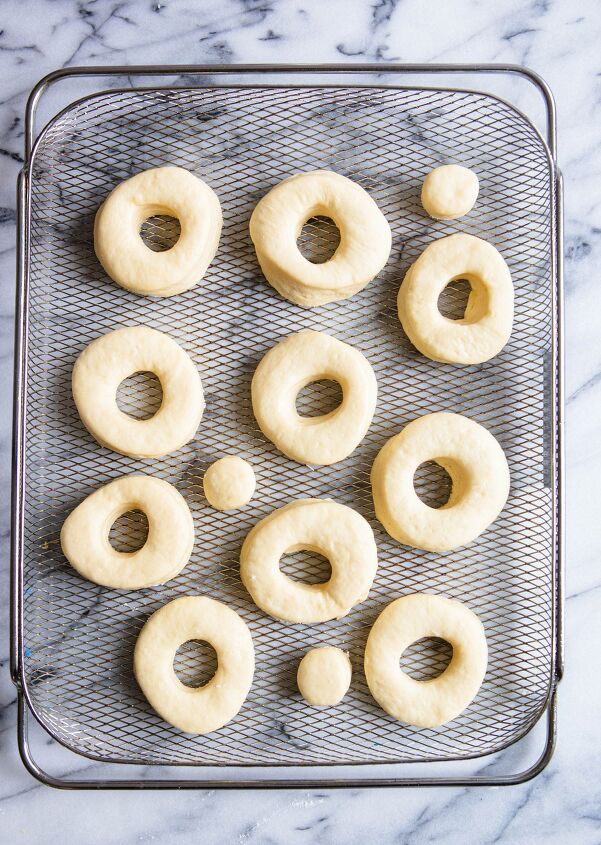 valentine donuts in air fryer basic recipe, donuts in air fryer basket set against a marble countertop