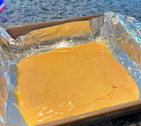 tiger butter fudge recipe easy, before pouring the melted semi sweet chocolate on top close up of melted white chocolate in baking dish