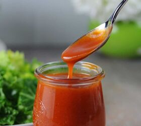 homemade sweet catalina dressing, a spoon pouring salad dressing into a small jar