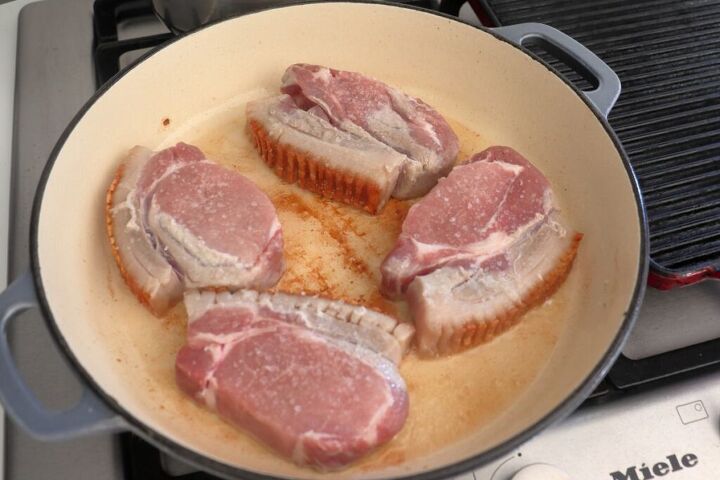 Pork loin chops searing in a pan