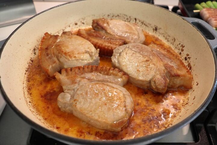 Pork loin chops cooking in a pan