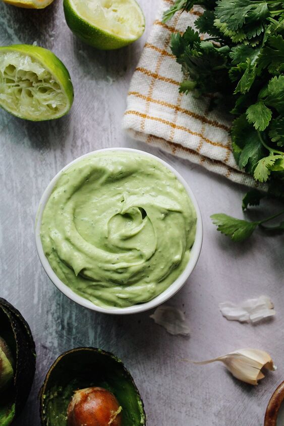 avocado cream sauce, avocado cream sauce in a small white bowl surrounded by ingredients
