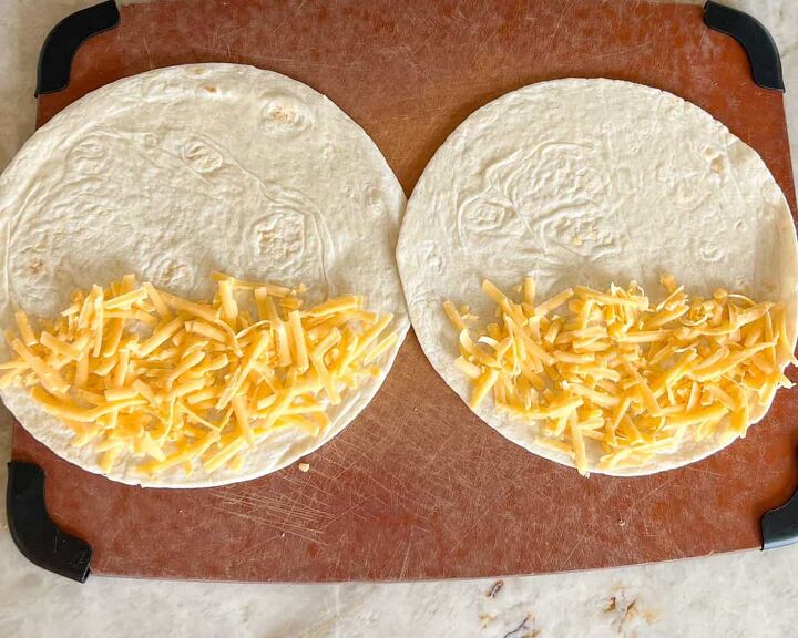 leftover pork tenderloin quesadillas, Overhead shot of two flour tortillas open with grated cheese on half of each