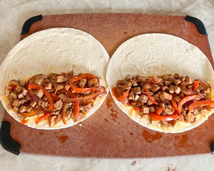 leftover pork tenderloin quesadillas, two tortillas open with pork onion mixture on half of each