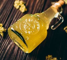 how to make elderflower cordial, a glass sun bottle of elderflower cordial seems to glow from within leaving a magical site of yellow golden liquid