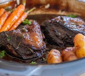 slow braised beef cheeks in a red wine sauce, Slow braised beef served in a dish with a red wine sauce and veg