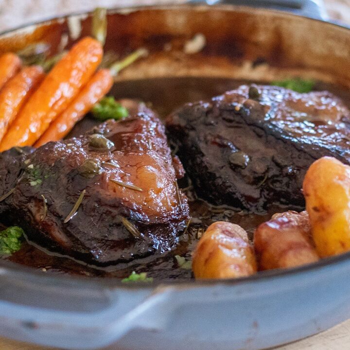 slow braised beef cheeks in a red wine sauce, Slow braised beef served in a dish with a red wine sauce and veg
