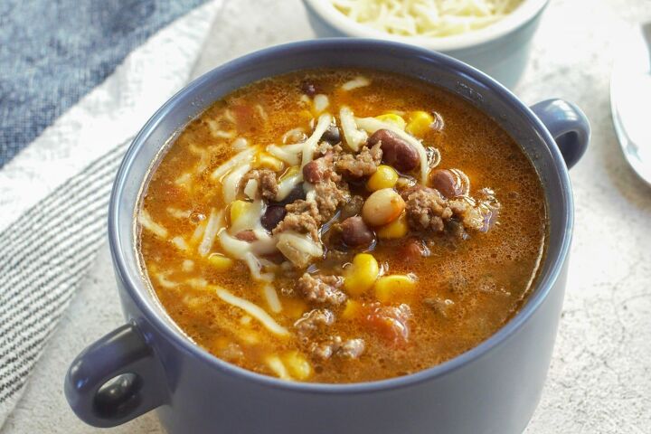 best dutch oven taco soup, Tex Mex style taco soup in a blue bowl