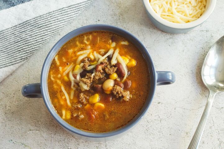 best dutch oven taco soup, Bowl of taco soup with ground beef ranch seasoning beans and corn