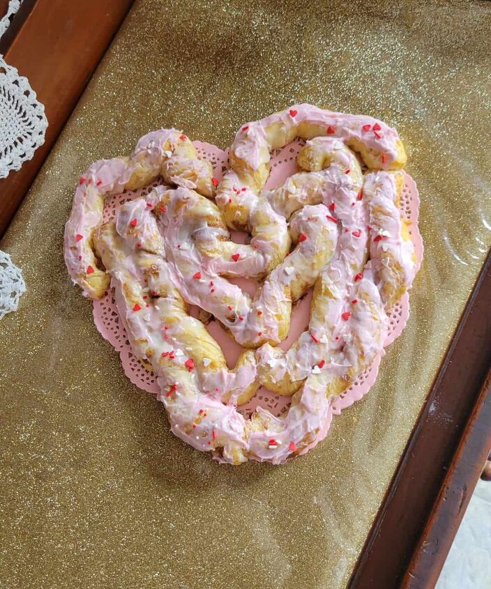heart shaped cinnamon roll, pink frosting and sprinkles